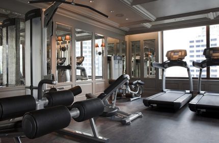 Hotel Muse Bangkok Langsuan gym. Treadmills, weight machines, and mirrored walls in the fitness center of this gay-friendly MGallery Collection hotel.