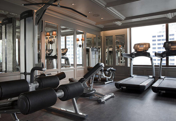 Hotel Muse Bangkok Langsuan gym. Treadmills, weight machines, and mirrored walls in the fitness center of this gay-friendly MGallery Collection hotel.