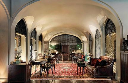 Hotel Muse Bangkok Langsuan, a gay-friendly MGallery Collection hotel. Lobby interior with arched ceilings, leather seating, and ornate details.
