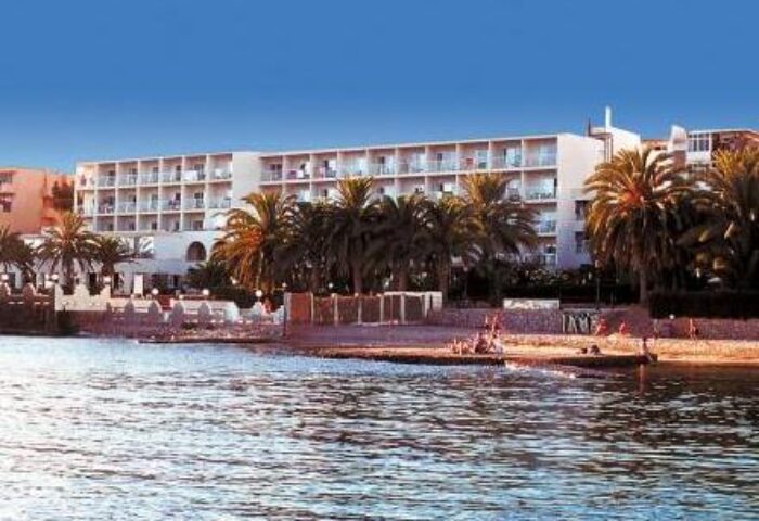 Hotel Nautico Ebeso, a gay-friendly hotel. Beachfront view of the hotel with palm trees, beach, and ocean. Perfect for gay travel.