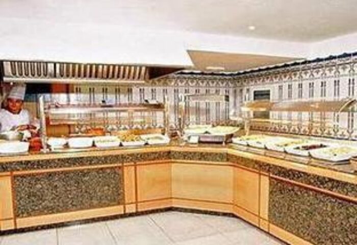 Gay-Friendly Hotel Nautico Ebeso buffet. Wide shot of a buffet with a chef in the background. Gay travel advice for Ibiza hotels.