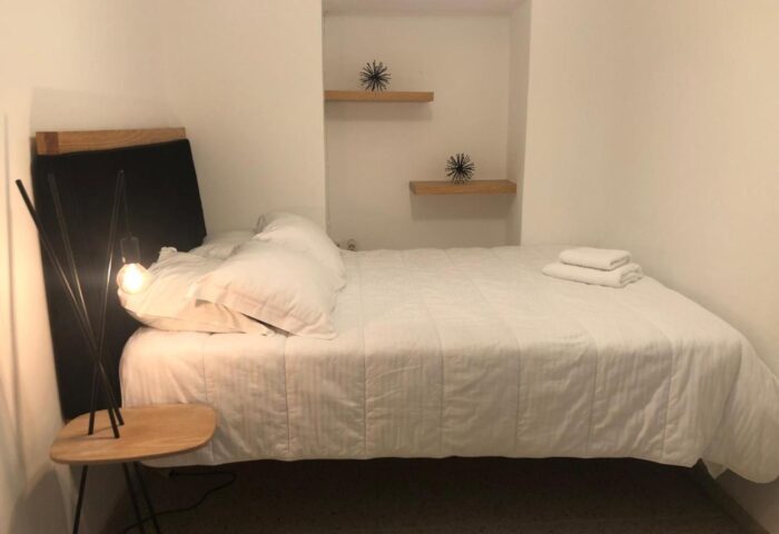 Hotel Nazos, Mykonos Town: Gay-friendly hotel room with double bed, white linens, bedside table, and modern decor. Ideal for gay travelers' stay.