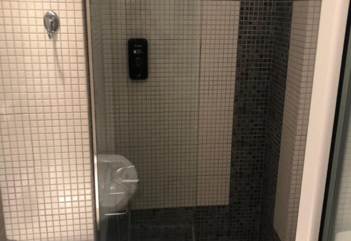 Bathroom at Gay-Friendly Hotel Nazos, Mykonos Town. Features tiled shower, sink. Ideal for gay travelers seeking Mykonos accommodation.