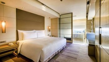 Hotel Nikko Saigon gay-friendly room. King bed, ensuite bathroom with tub. Upscale Saigon hotel for gay travelers. Modern, luxury design.