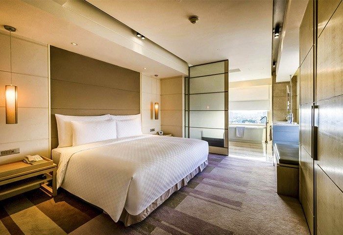 Hotel Nikko Saigon gay-friendly room. King bed, ensuite bathroom with tub. Upscale Saigon hotel for gay travelers. Modern, luxury design.