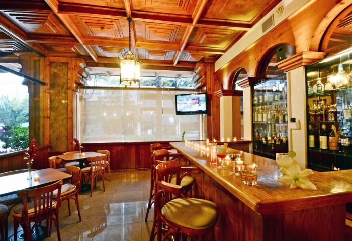 Hotel PF's bar interior. Gay-friendly Hotel PF features a classic wood bar, tables, and a relaxing atmosphere. Perfect for gay travelers.
