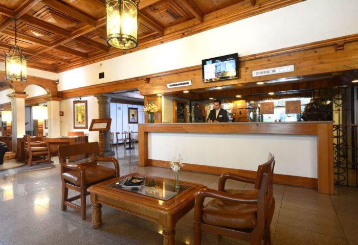 Hotel PF's lobby. Gay-friendly Hotel PF features wood accents, leather chairs, and a reception desk. A welcoming space for gay travelers.