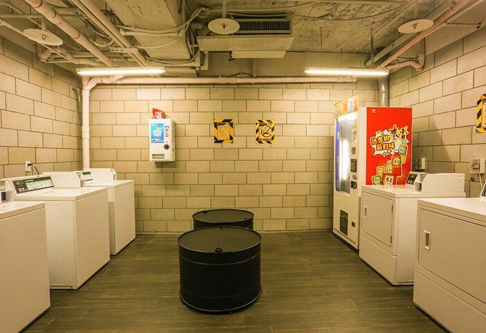 Hotel PaPa Whale gay-friendly hotel laundry room. Washing machines, vending machines, and barrel tables. A convenient amenity for gay travelers.