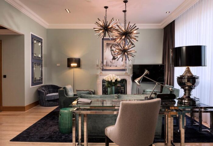 Hotel Palace Berlin's pet-friendly room. Gay-friendly hotel living room with modern design, chandeliers, and stylish furniture.