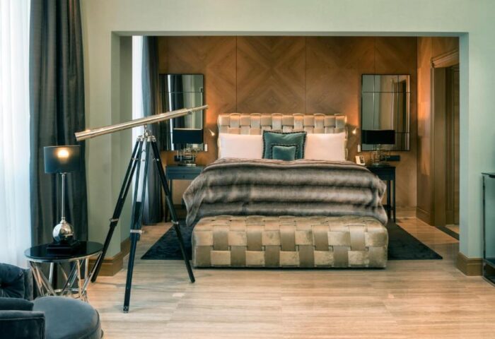 Hotel Palace Berlin's pet-friendly room. Gay-friendly hotel with bed, telescope, and luxurious decor. Ideal for gay men travel.