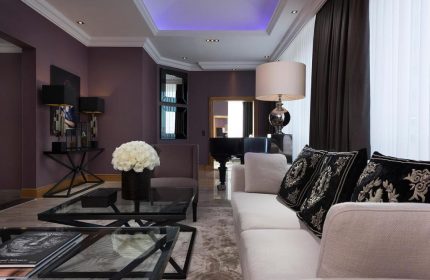 Hotel Palace Berlin's gay-friendly, pet-friendly suite. Living room with piano, sofa, and stylish decor. Luxury stay for gay travelers.