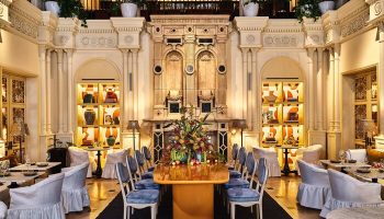Hotel Per La, Autograph Collection dining room. Gay-friendly hotel interior with elegant decor, tables, and chairs. Luxurious design.