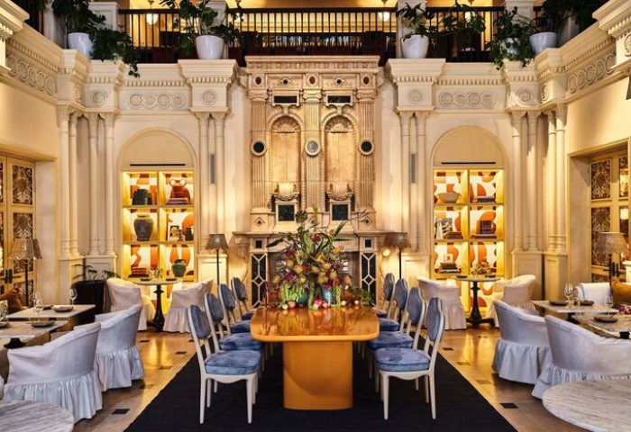 Hotel Per La, Autograph Collection dining room. Gay-friendly hotel interior with elegant decor, tables, and chairs. Luxurious design.