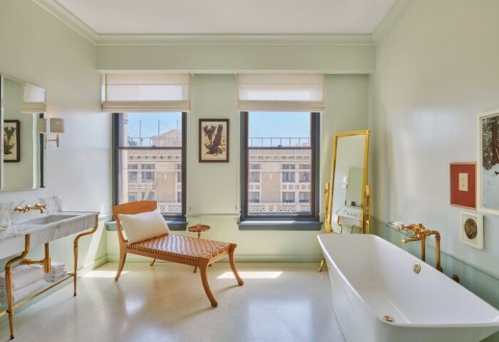 Hotel Per La, Autograph Collection bathroom. Gay-friendly hotel with tub, chair, sink, and city views. Luxury travel for gay men.