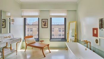 Hotel Per La, Autograph Collection bathroom. Gay-friendly hotel with tub, chair, sink, and city views. Luxury travel for gay men.