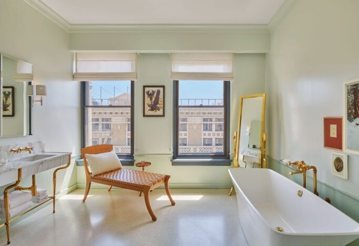 Hotel Per La, Autograph Collection bathroom. Gay-friendly hotel with tub, chair, sink, and city views. Luxury travel for gay men.