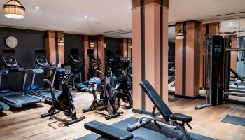Hotel Per La, Autograph Collection gym. Treadmills, bikes, and weight machines in a modern, gay-friendly hotel. Fitness center.