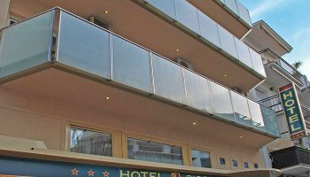 Hotel Piccadilly Sitges facade. Gay-friendly hotel with modern glass balconies. A popular choice for gay men visiting Sitges, Spain.