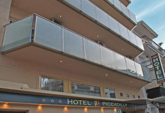 Hotel Piccadilly Sitges facade. Gay-friendly hotel with glass balconies. A great option for gay men's travel in Sitges, Spain.