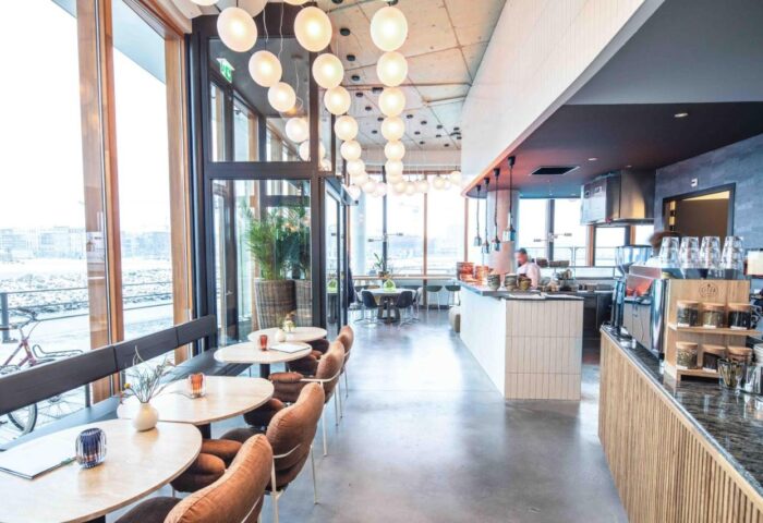 Hotel Pontsteiger's stylish interior. Gay-friendly hotel with modern design, cafe, and waterfront views. Perfect for gay travelers' Amsterdam visit.