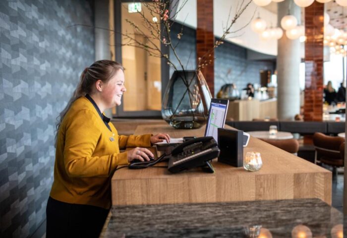 Hotel Pontsteiger's friendly staff welcomes gay travelers. Receptionist at the front desk of this gay-friendly hotel in Amsterdam.
