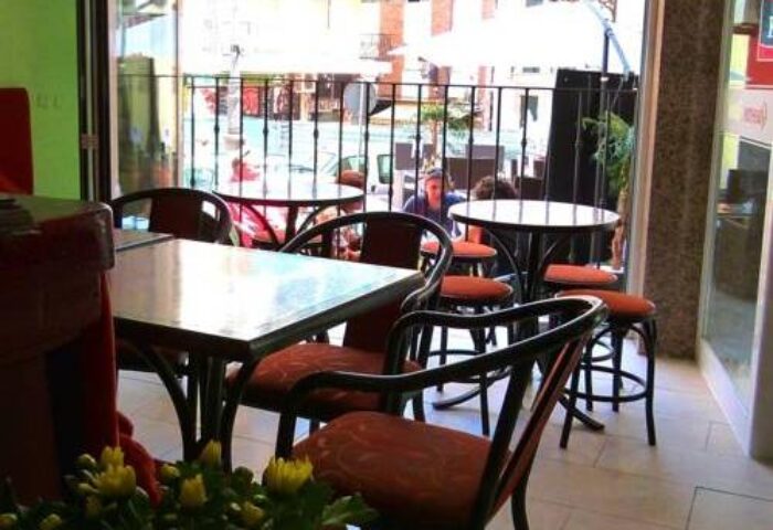 Hotel Queens Adults Only By Mc: Interior view of the gay-friendly hotel's cafe, tables and chairs, outdoor seating area visible.