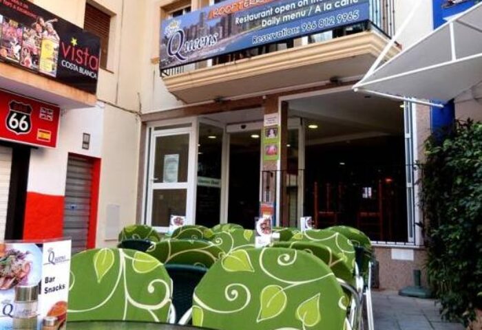 Hotel Queens Adults Only By Mc, a gay-friendly hotel. Outdoor seating area with green chairs. A rooftop terrace offers dining. Costa Blanca.