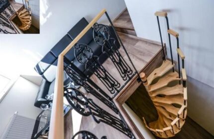 Hotel Residence Spalena's interior: spiral staircase, black iron railings, and a black leather couch. Gay-friendly hotel in Prague.