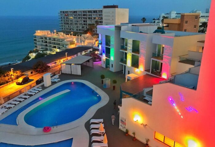 Hotel Ritual Torremolinos Adults Only, a gay-friendly hotel. Night view of the pool and illuminated building. Gay travel advice.