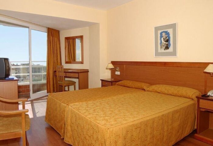 AluaSun Flamingo Hotel room with twin beds, desk, and balcony. A gay-friendly hotel. Comfortable accommodations for your travel plans.