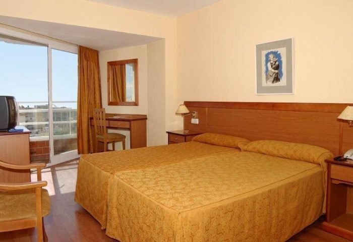 AluaSun Flamingo Hotel room with twin beds, desk, and balcony. A gay-friendly hotel. Comfortable accommodations for your travel plans.