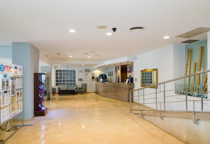 AluaSun Flamingo Hotel lobby. Gay-friendly hotel reception area with seating, info stand, and ramp. Roc Flamingo interior for gay travel.