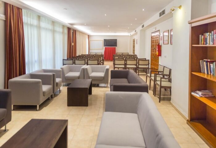 AluaSun Flamingo hotel conference room with modern seating. Gay-friendly hotel interior for meetings and events. Roc Flamingo hotel space.