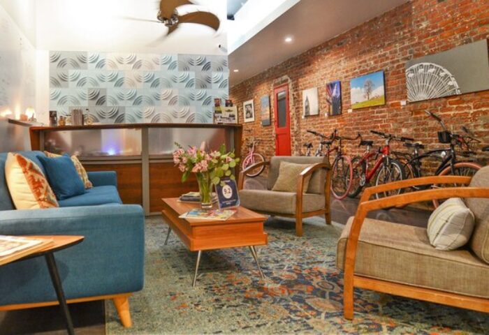 Hotel Royal's gay-friendly vibe: cozy lobby with exposed brick, bikes, and stylish furniture. Perfect for gay travelers seeking comfort.