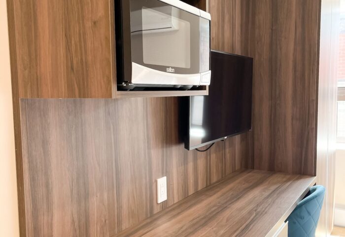 Hotel Saint-Andre gay-friendly hotel room. Desk and microwave. Modern amenities for gay travelers. Comfortable stay in Paris.