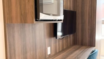 Hotel Saint-Andre gay-friendly hotel room. Desk and microwave. Modern amenities for gay travelers. Comfortable stay in Paris.