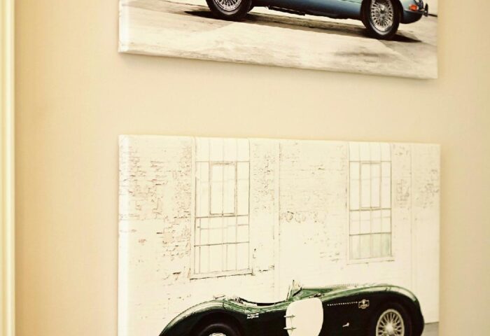 Hotel Sans Souci Wien decor: Two classic car art prints. Gay-friendly hotel design detail. Blue and green vintage sports cars.
