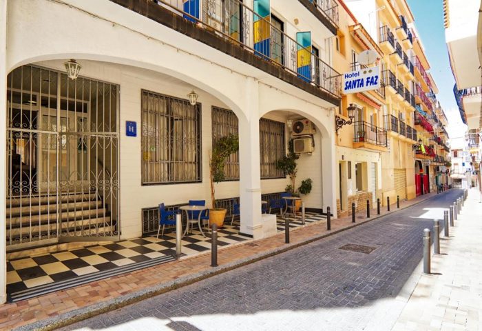 Hotel Santa Faz, gay-friendly adults-only hotel. Exterior view of the hotel in a narrow street. Quaint architecture, inviting atmosphere.