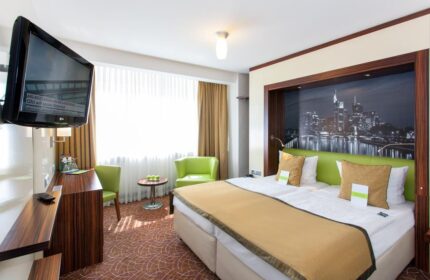 Hotel Scala: Gay-friendly hotel room. Double bed with city view, TV, desk, and chairs. Comfortable stay for gay travelers. #gaytravel