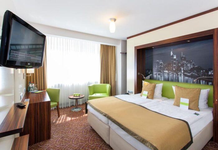 Hotel Scala: Gay-friendly hotel room. Double bed with city view, TV, desk, and chairs. Comfortable stay for gay travelers. #gaytravel