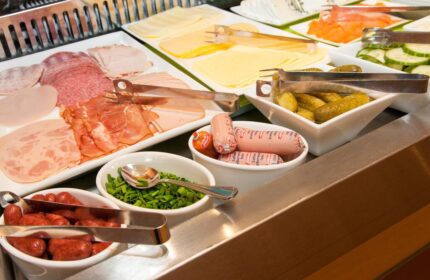 Hotel Scala's breakfast buffet offers a variety of cold cuts, cheeses, sausages, and pickles. A gay-friendly hotel with delicious options.