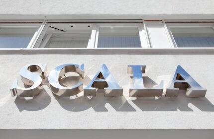Hotel Scala sign. Gay-friendly Hotel Scala's exterior signage. Metal letters spelling Scala on a white building. Gay travel lodging.