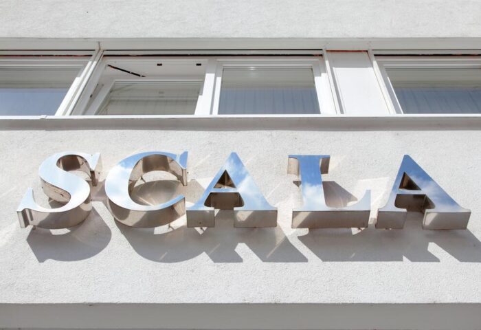 Hotel Scala sign. Gay-friendly Hotel Scala's exterior signage. Metal letters spelling Scala on a white building. Gay travel lodging.