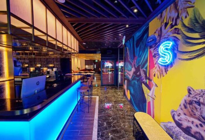 Hotel Soloha @ Chinatown interior. Gay-friendly hotel bar with blue lighting, vibrant wall art, and modern design. A stylish Singapore stay.