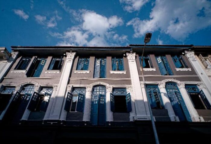Hotel Soloha @ Chinatown facade. Gray building with blue window shutters. Gay-friendly hotel architecture in Singapore.