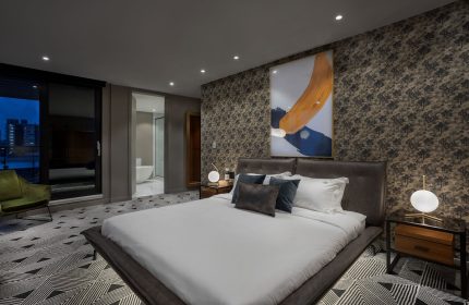 Hotel St. Thomas gay-friendly room. King bed, modern art, & city views. Upscale gay travel experience. Stylish decor. Relaxing vacation.