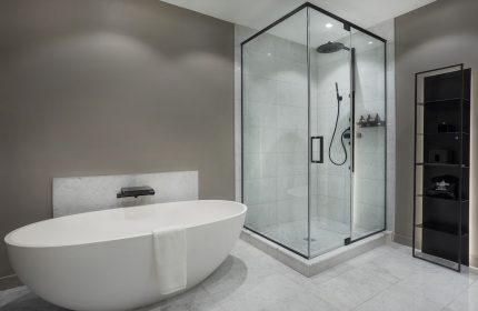 Hotel St. Thomas gay-friendly hotel bathroom. Features a modern tub, glass shower, and sleek shelving. Ideal for gay travelers seeking luxury.