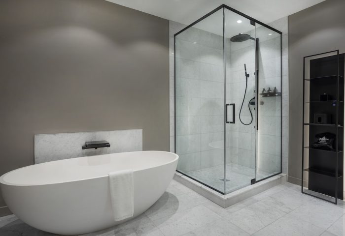 Hotel St. Thomas gay-friendly hotel bathroom. Features a modern tub, glass shower, and sleek shelving. Ideal for gay travelers seeking luxury.
