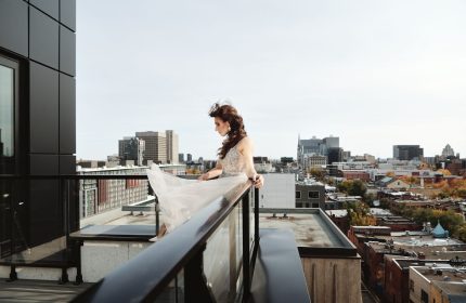 Hotel St. Thomas: A woman in a dress on a rooftop with a city view. Gay-friendly hotel for gay men travel.