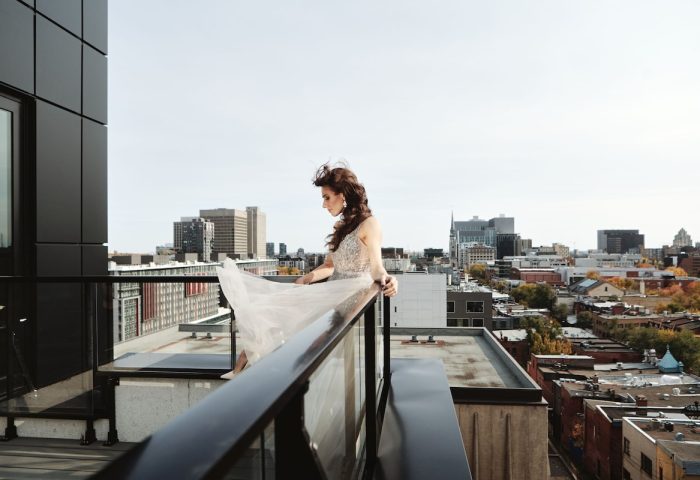 Hotel St. Thomas: A woman in a dress on a rooftop with a city view. Gay-friendly hotel for gay men travel.